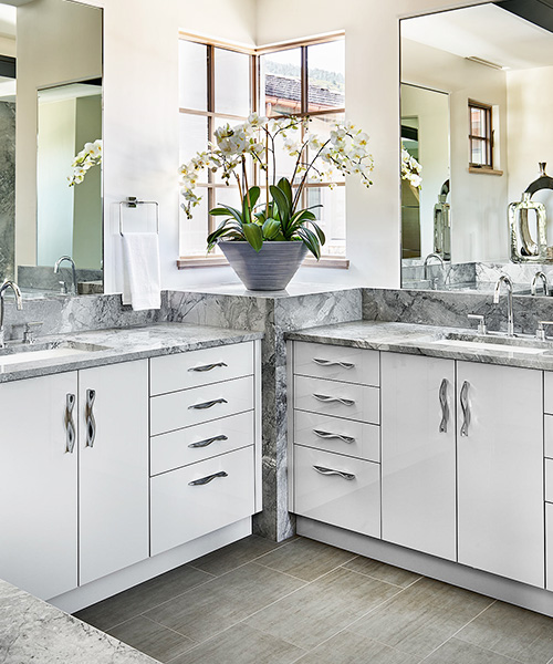 High-end bathroom remodel with white and grey accents designed by William Ohs in Denver