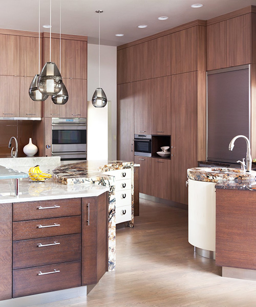 Medium-colored wood custom built cabinets in kitchen by William Ohs in Denver