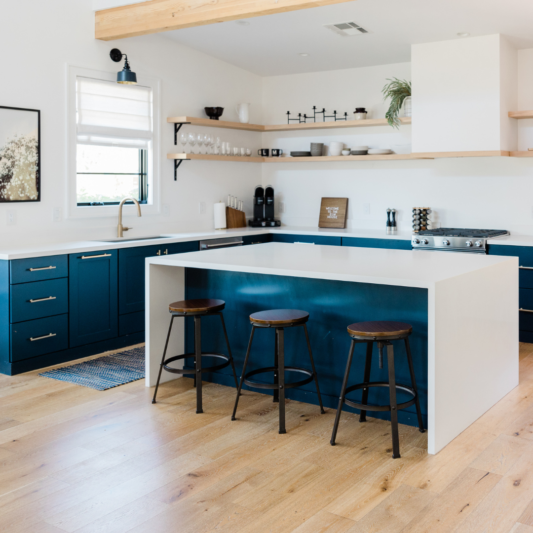 modern kitchen with dark teal cabinets and white counters