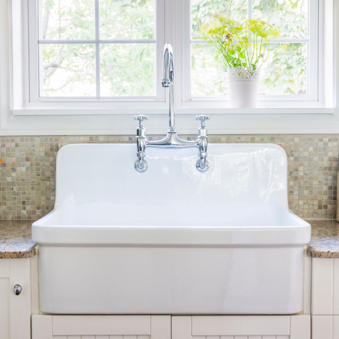 kitchen sink with mosaic marble backsplash