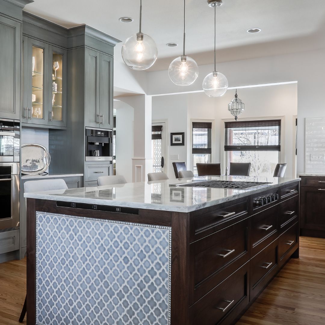 a brown and blue kitchen with green cabinets in the back