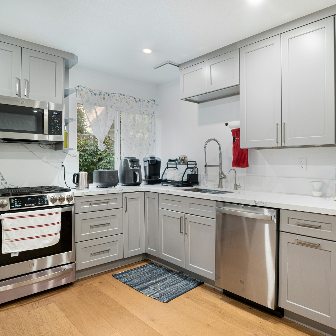A kitchen with gray cabinets